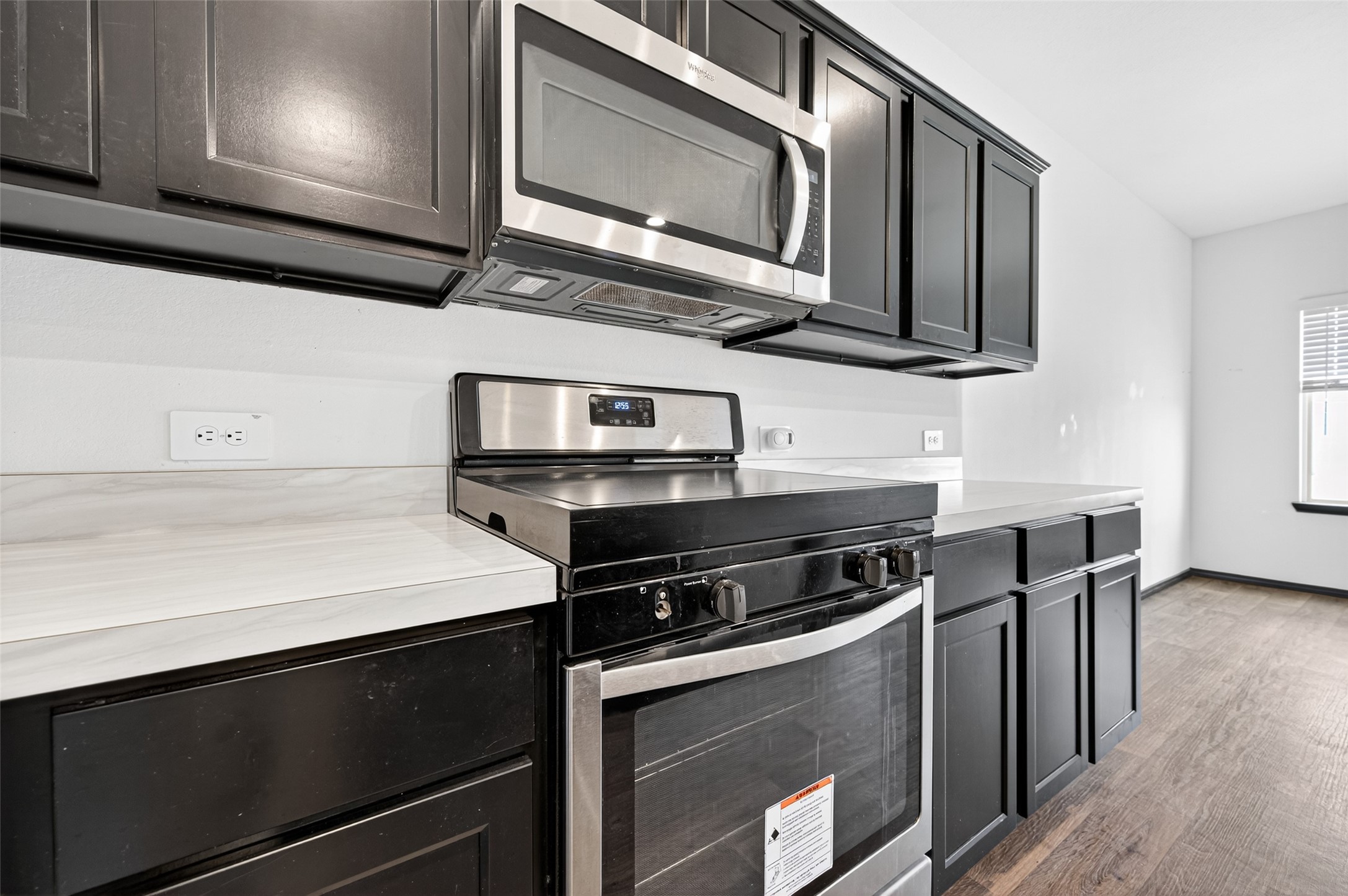 21538 Violet Rdg Road Katy, TX 77449 - Photo 13 of 39 a kitchen with stainless steel appliances a stove microwave and sink
