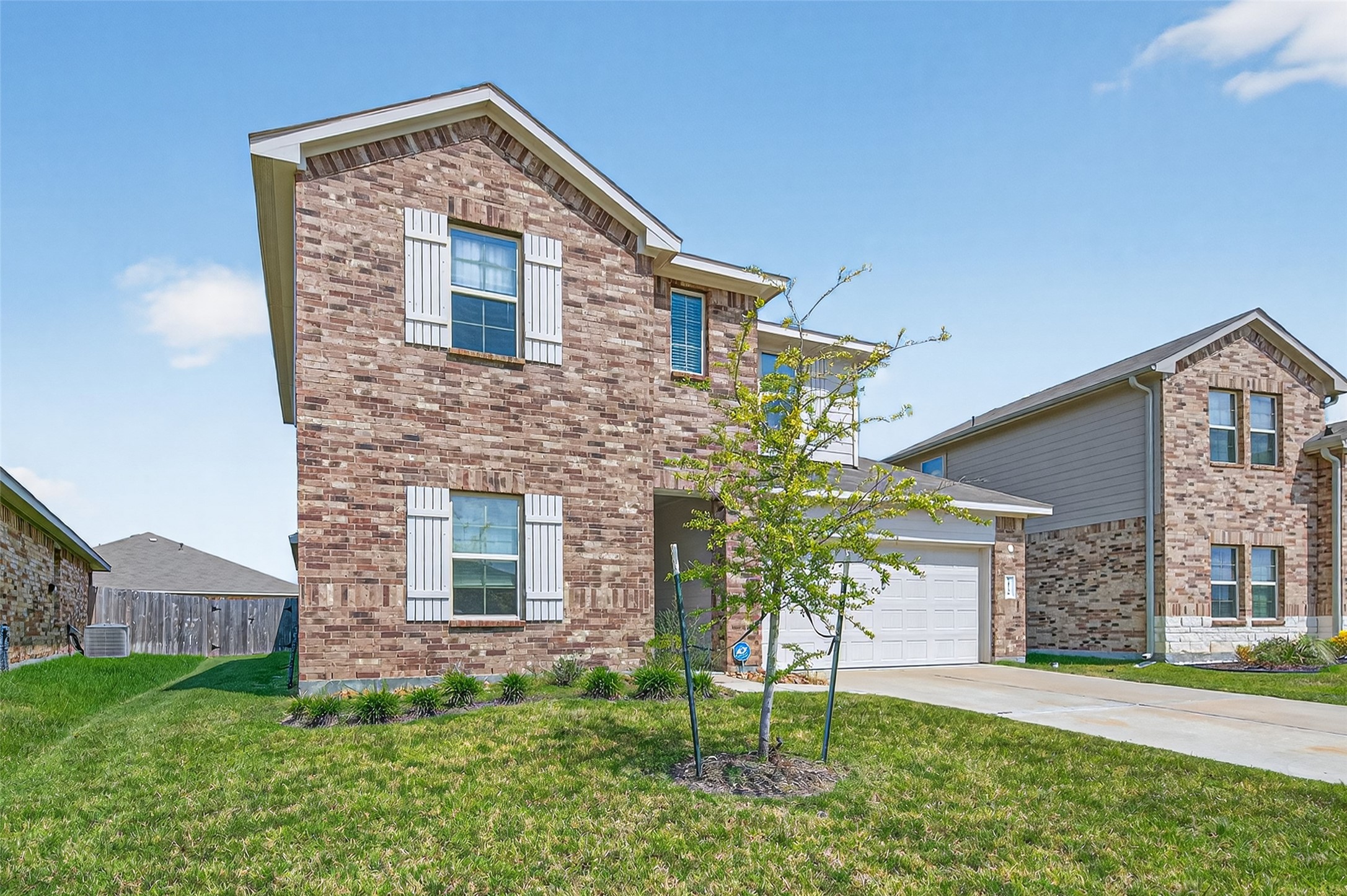 21538 Violet Rdg Road Katy, TX 77449 - Photo 2 of 39 a front view of a house with a yard and garage