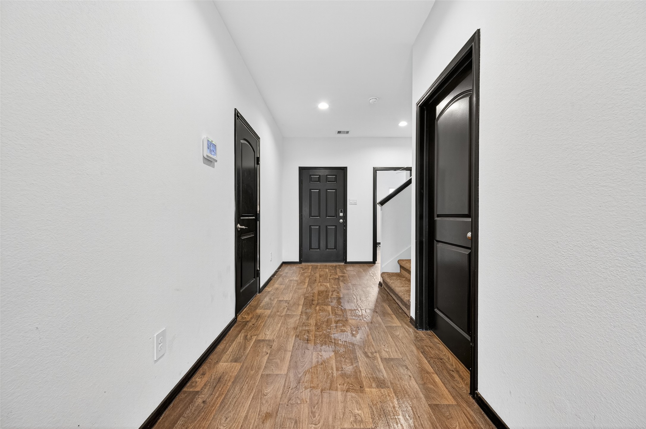 21538 Violet Rdg Road Katy, TX 77449 - Photo 4 of 39 a view of hallway with a large window and wooden floor