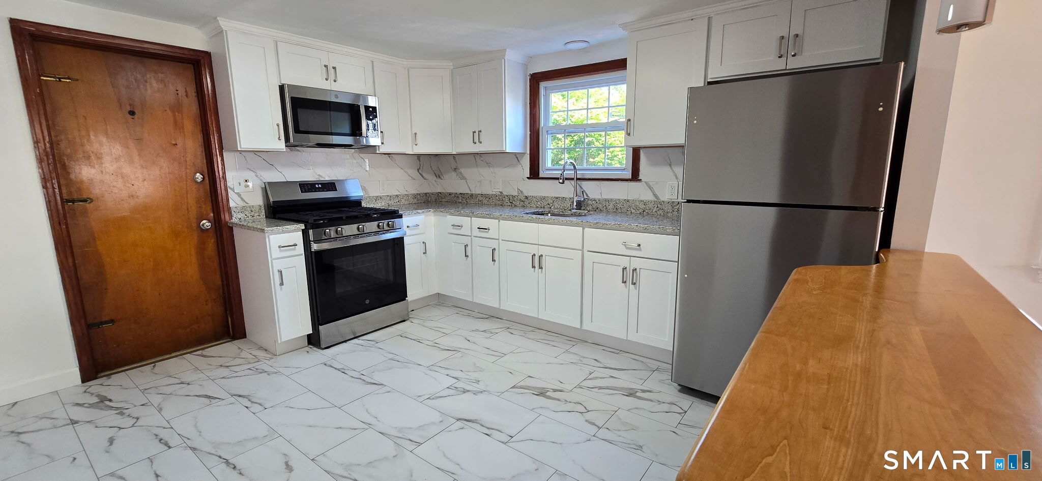 169 Arnoldale Road West Hartford, CT 06119 - Photo 4 of 11 a kitchen with stainless steel appliances a refrigerator sink and microwave
