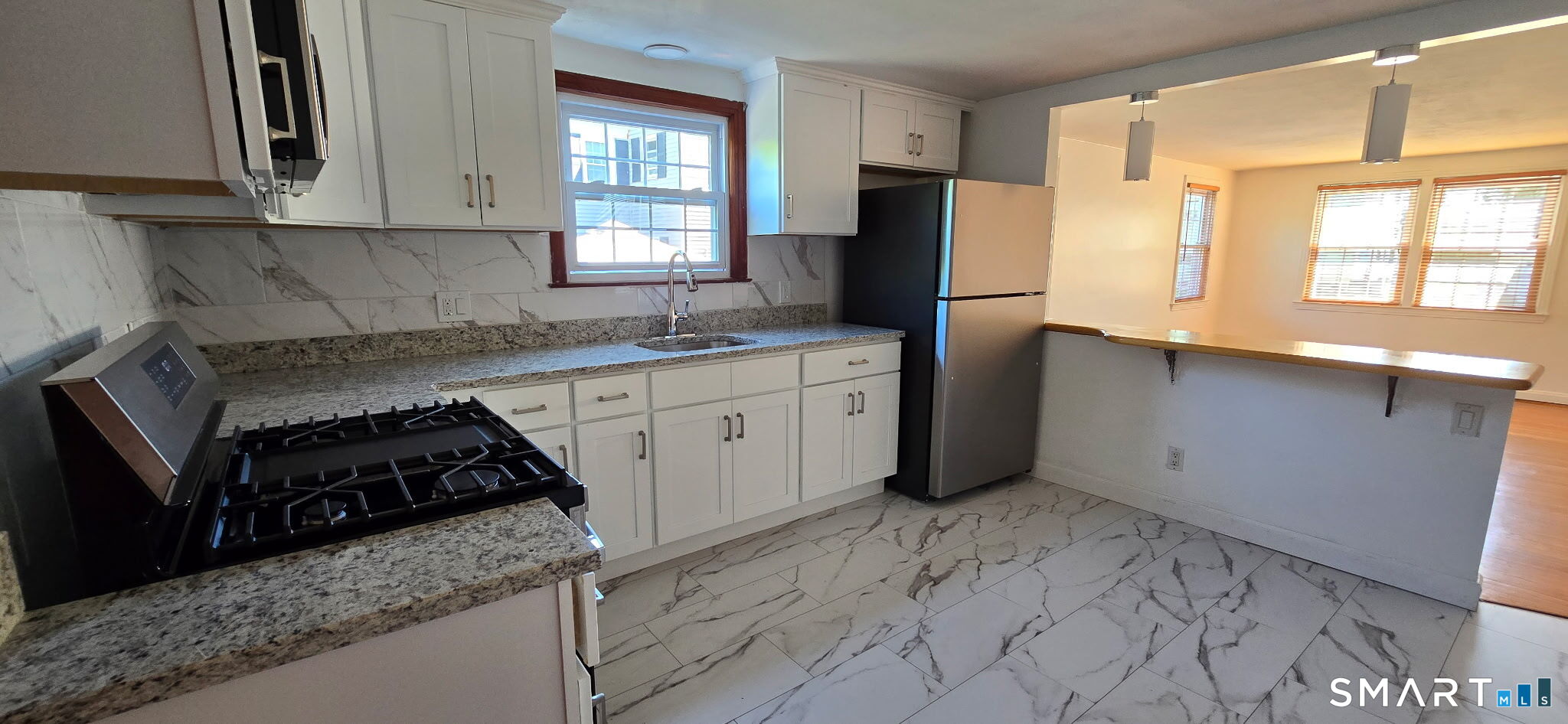 169 Arnoldale Road West Hartford, CT 06119 - Photo 5 of 11 a kitchen with granite countertop a refrigerator and a sink