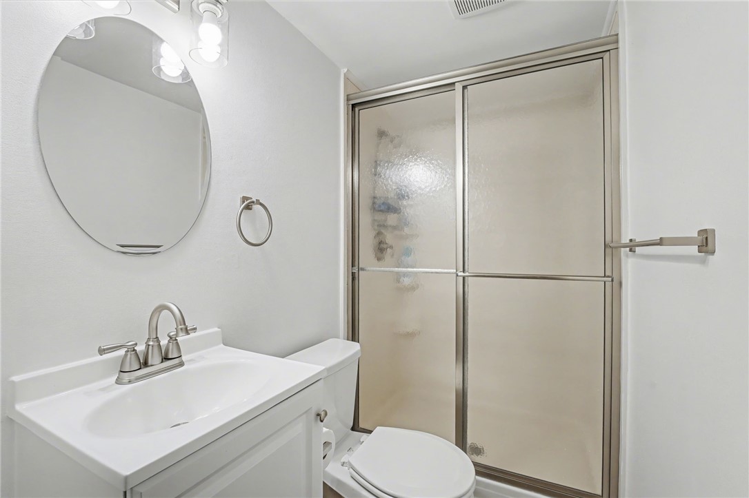 4919 Silver Arrow Drive Riverside, OH 45424 - Photo 42 of 57 This bathroom features a sleek vanity, mirror, and a convenient shower with sliding glass doors.