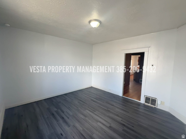 471 East 22nd Street Ogden, UT 84401 - Photo 2 of 12 Empty room with dark wood finished floors and a textured ceiling