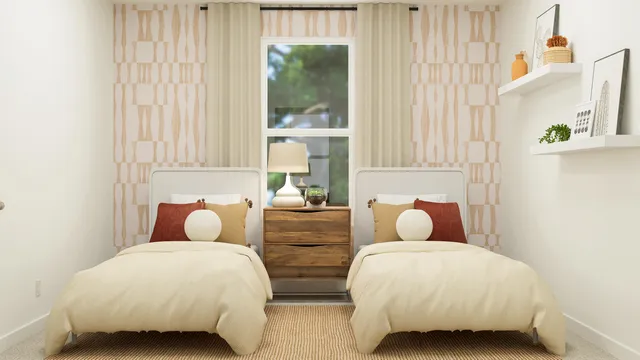 a bedroom with two beds and a window