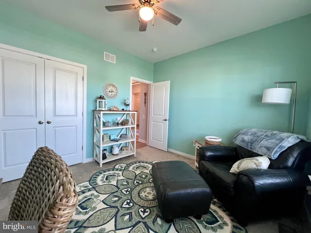 a kitchen with granite countertop a table chairs microwave and cabinets