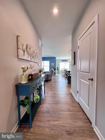 a living room with furniture kitchen view and a large window