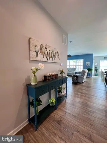 a living room with furniture flat screen tv and a large window