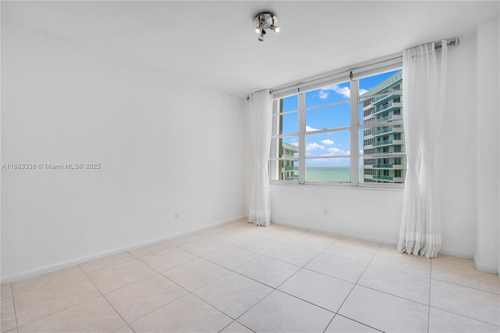 5151 Collins Avenue, Unit 925 Miami Beach, FL 33140 - Photo 13 of 23 a view of an empty room with a window