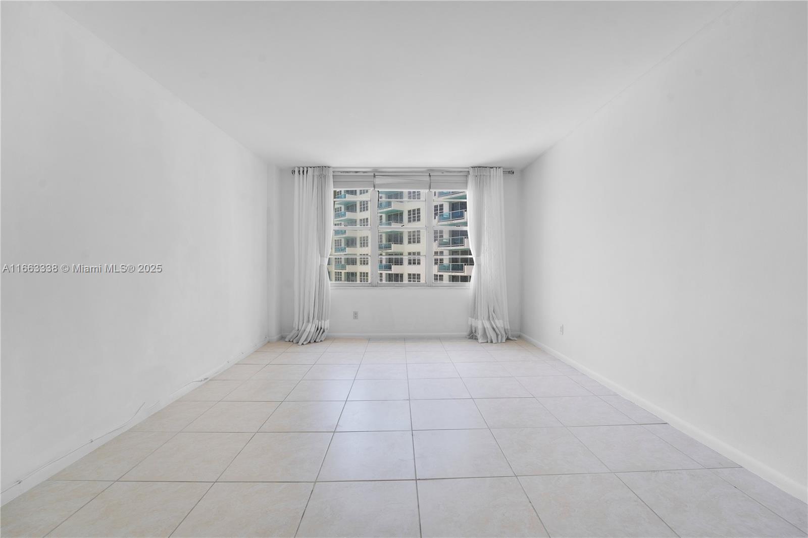 5151 Collins Avenue, Unit 925 Miami Beach, FL 33140 - Photo 15 of 23 an empty room with windows