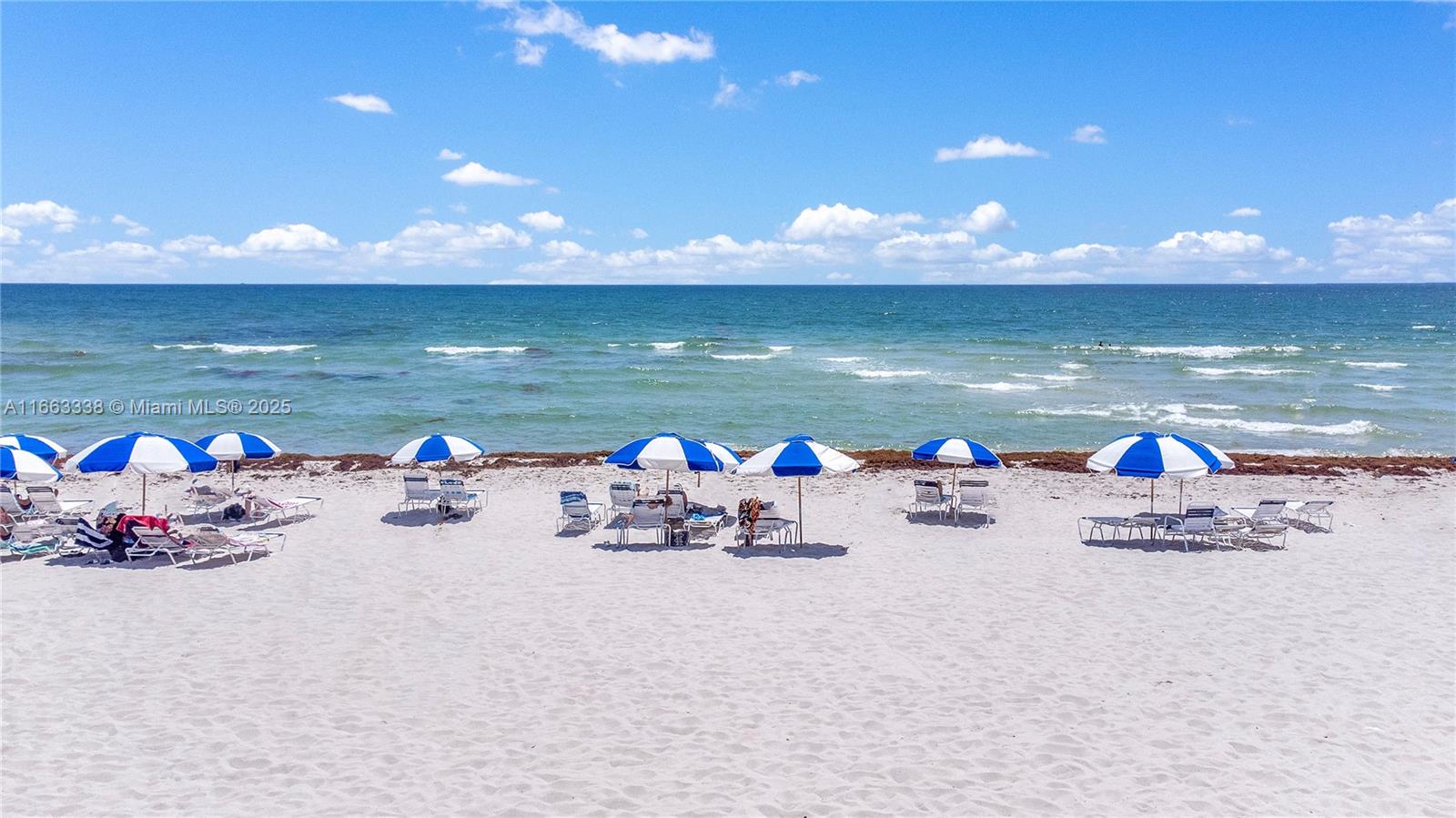5151 Collins Avenue, Unit 925 Miami Beach, FL 33140 - Photo 19 of 23 a view of a lake with a chairs and table on the patio