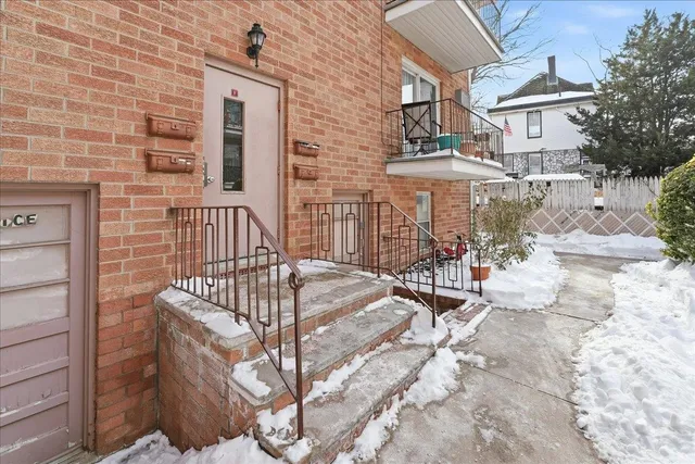 a view of a brick house with many windows
