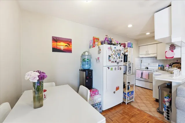 a dining room with furniture and wooden floor