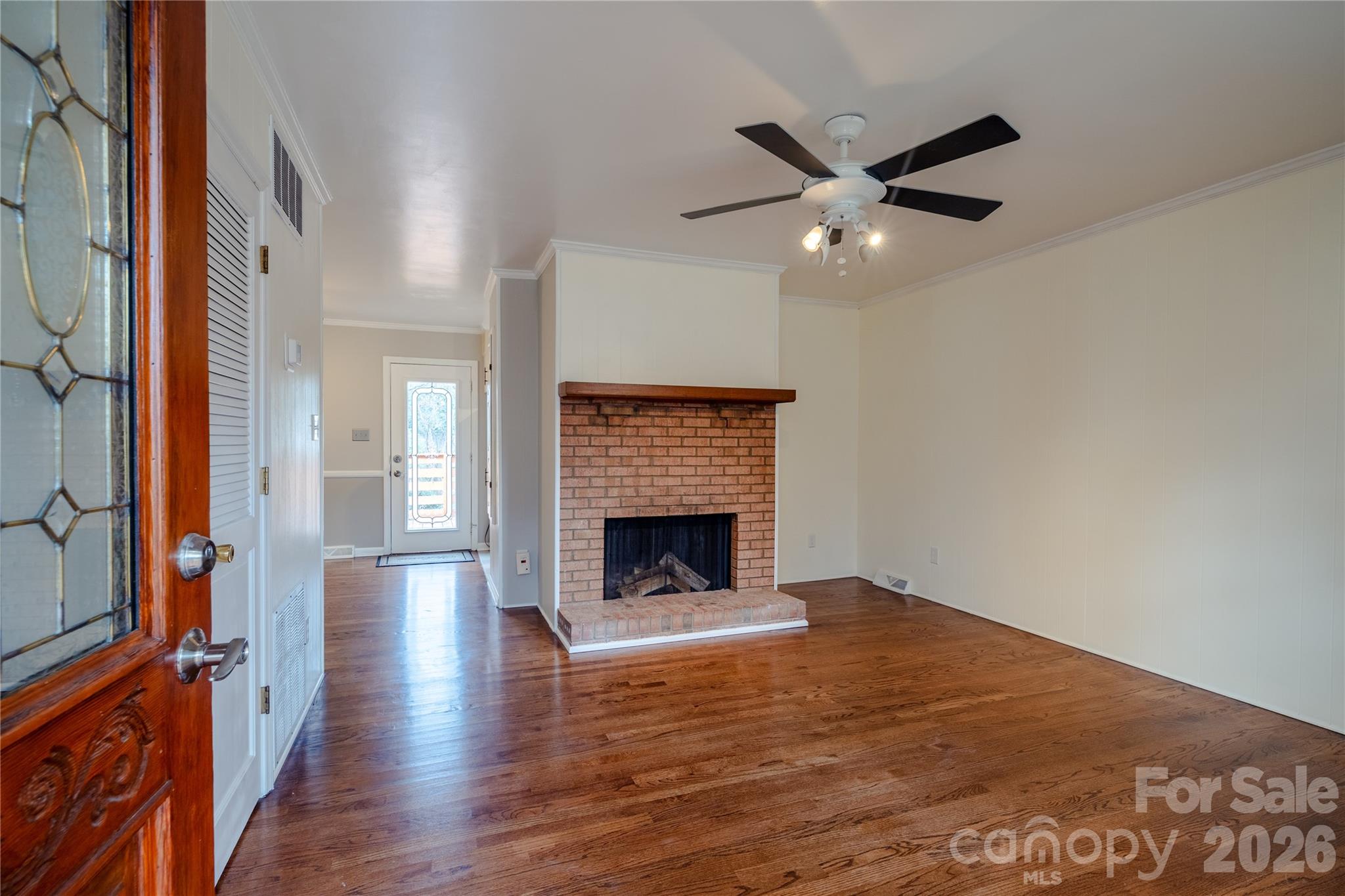 5315 Ruth Drive Charlotte, NC 28215 - Photo 11 of 38 a view of an empty room with wooden floor fireplace and a window