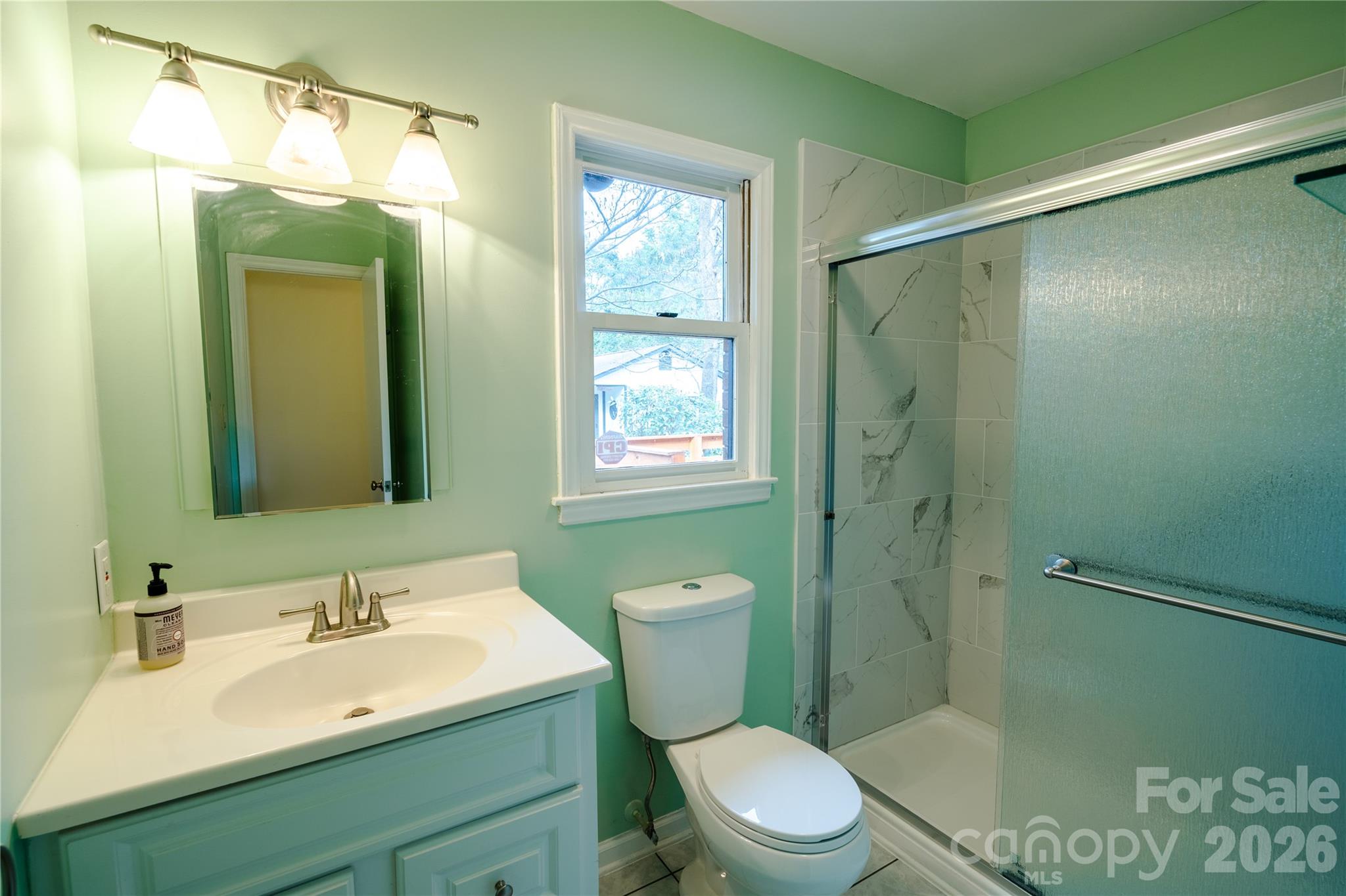 5315 Ruth Drive Charlotte, NC 28215 - Photo 19 of 38 a bathroom with a sink a toilet and shower
