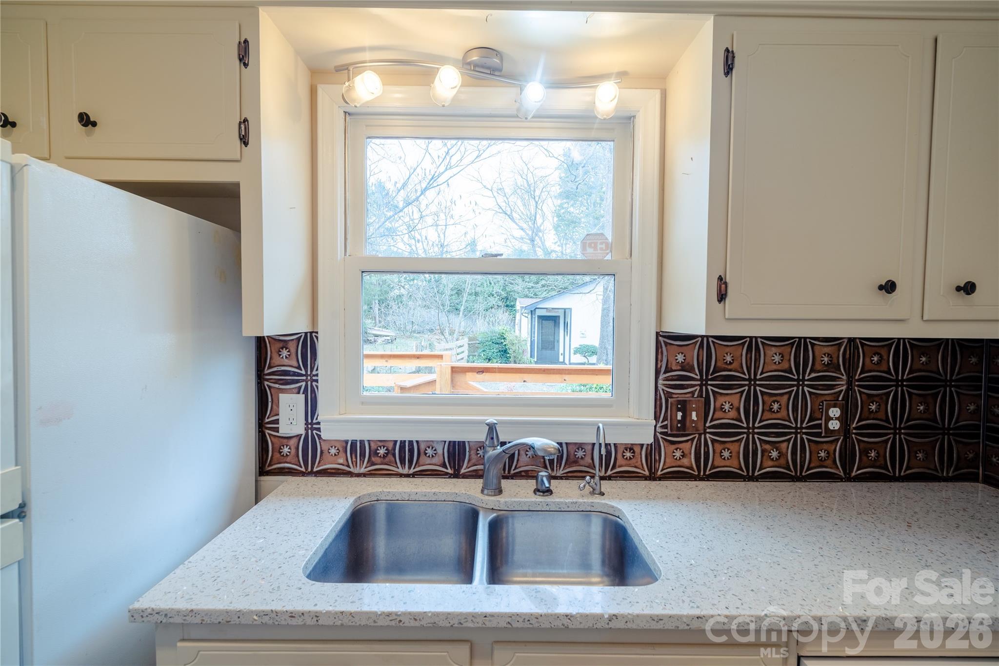 5315 Ruth Drive Charlotte, NC 28215 - Photo 27 of 38 a kitchen with a sink window and cabinets