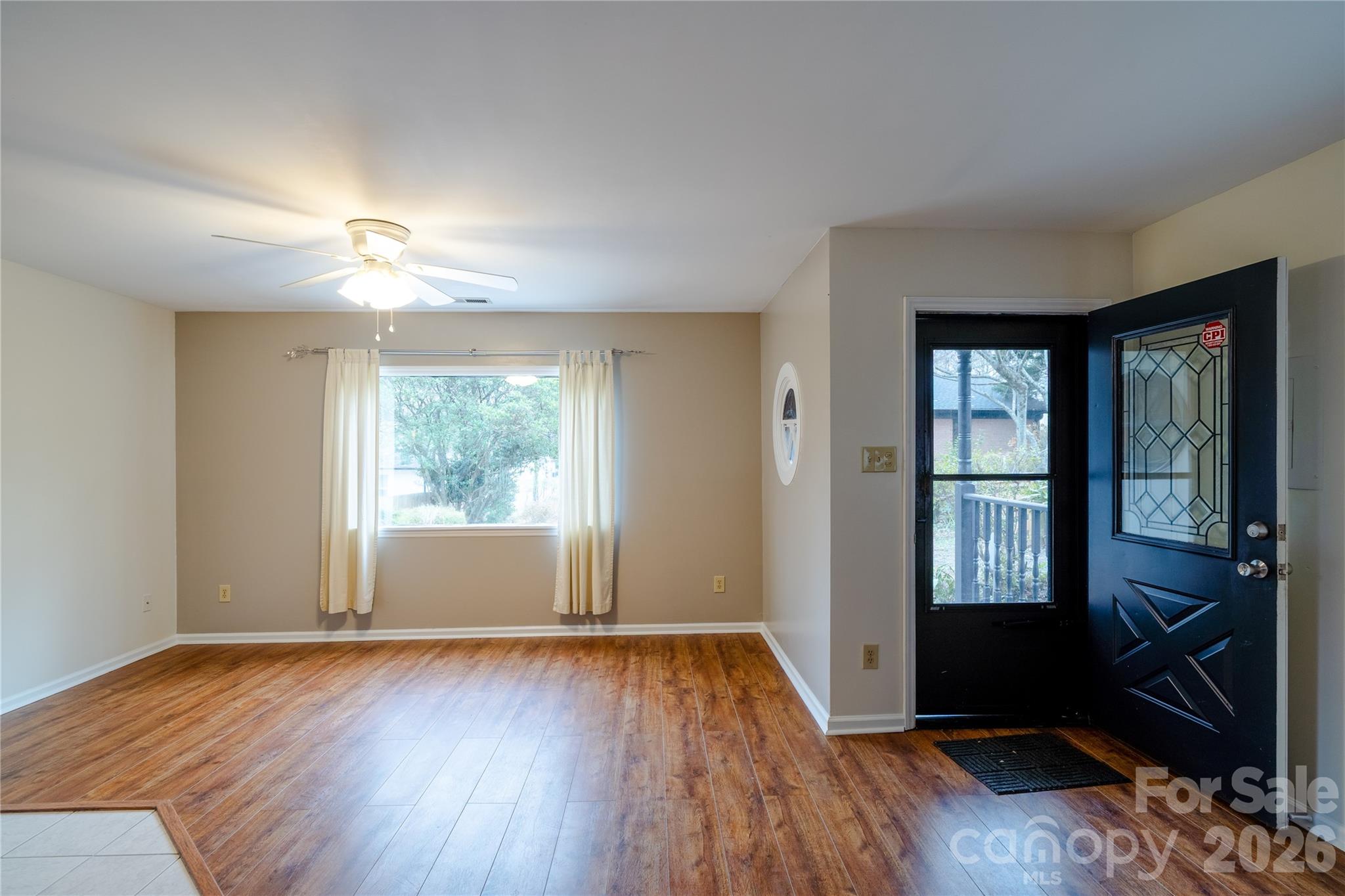 5315 Ruth Drive Charlotte, NC 28215 - Photo 4 of 38 an empty room with wooden floor and windows