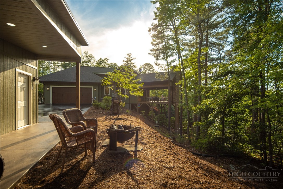 115 Passionflower Trail Boone, NC 28607 - Photo 35 of 50 a backyard of a house with table and chairs