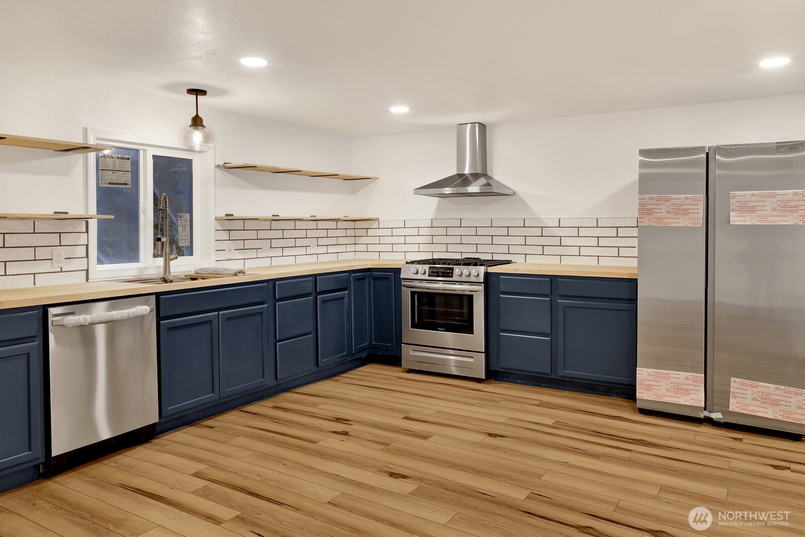 13574 South Green Street Anacortes, WA 98221 - Photo 13 of 26 a kitchen with stainless steel appliances granite countertop wooden cabinets and a sink