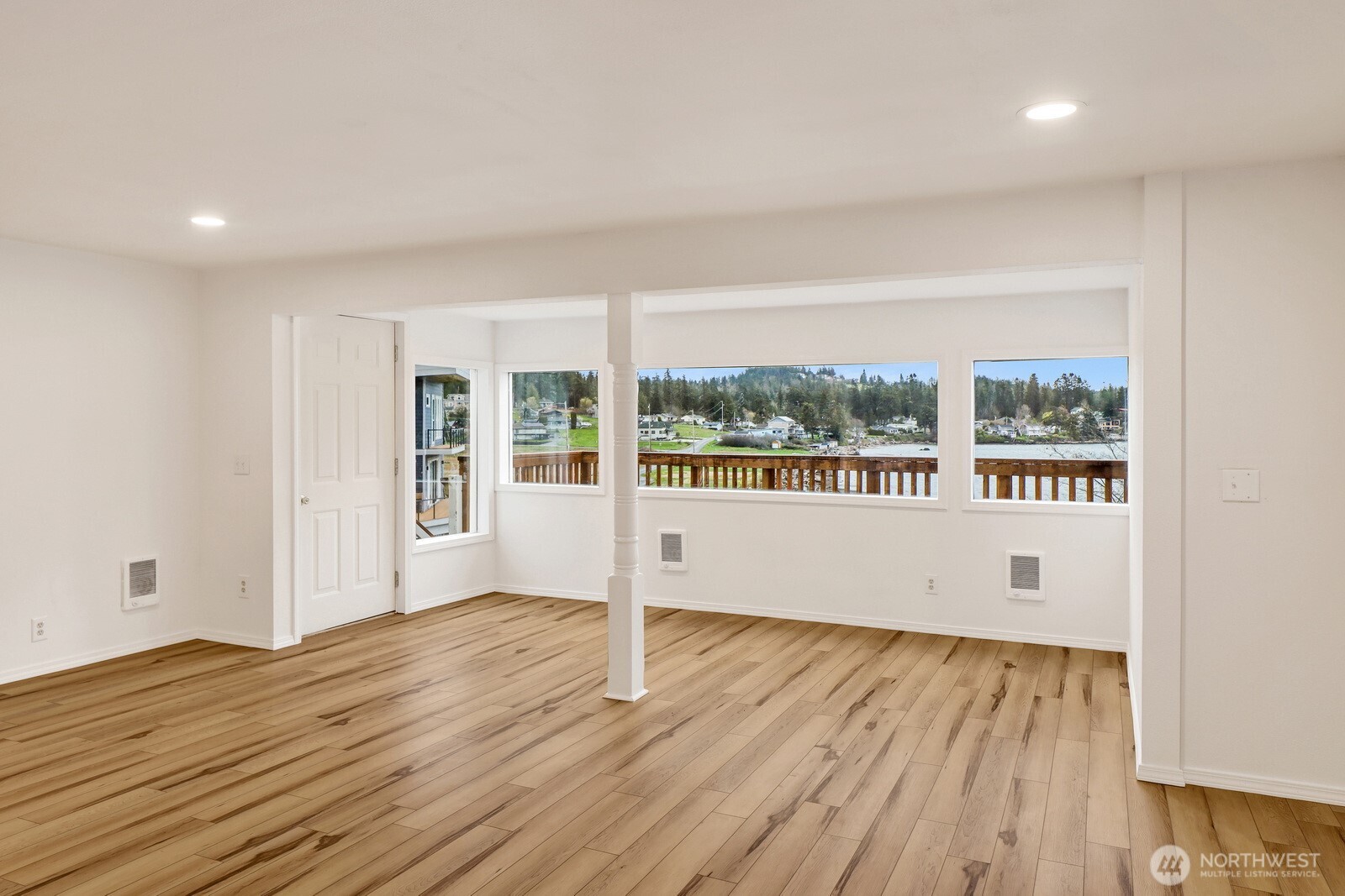 13574 South Green Street Anacortes, WA 98221 - Photo 10 of 26 a view of an empty room with wooden floor and a window
