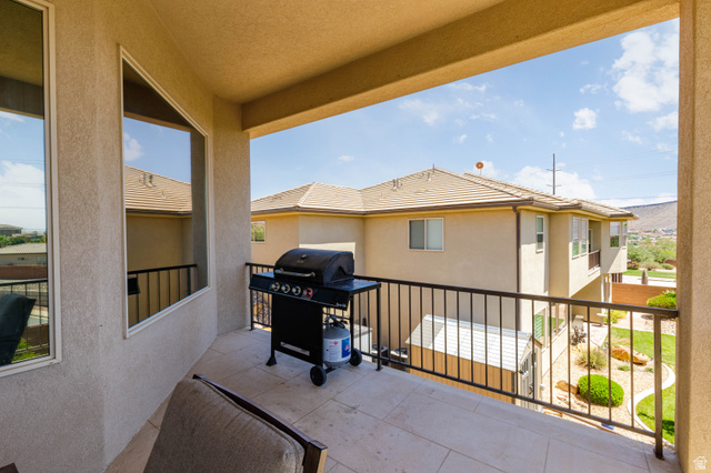 2005 West 450 S Circle St. George, UT 84770 - Photo 14 of 57 Covered patio featuring a tiled floor, stucco exterior, and black metal railing