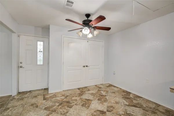 a view of a chandelier fan and closet in a room