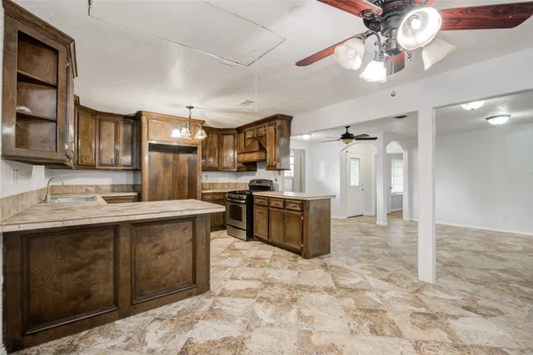 a kitchen with stainless steel appliances granite countertop a sink and cabinets
