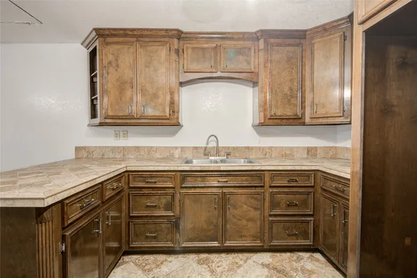 a kitchen with stainless steel appliances granite countertop a sink and cabinets