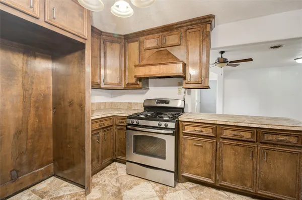 a kitchen with a stove oven and a window