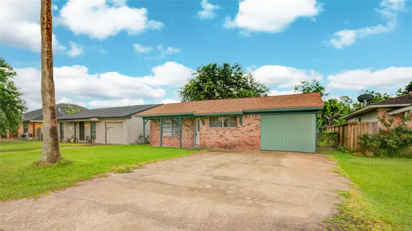 a front view of a house with a garden and yard
