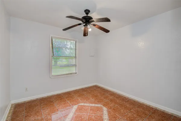 a view of empty room with ceiling fan