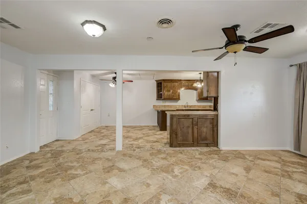 a view of a kitchen with a sink and a refrigerator