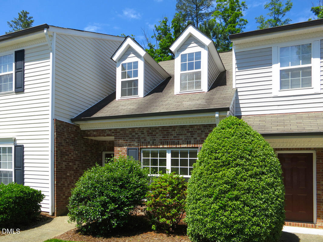 101 Rock Haven Road, Unit E502 Carrboro, NC 27510 - Photo 13 of 16 a front view of a house with a yard and potted plants