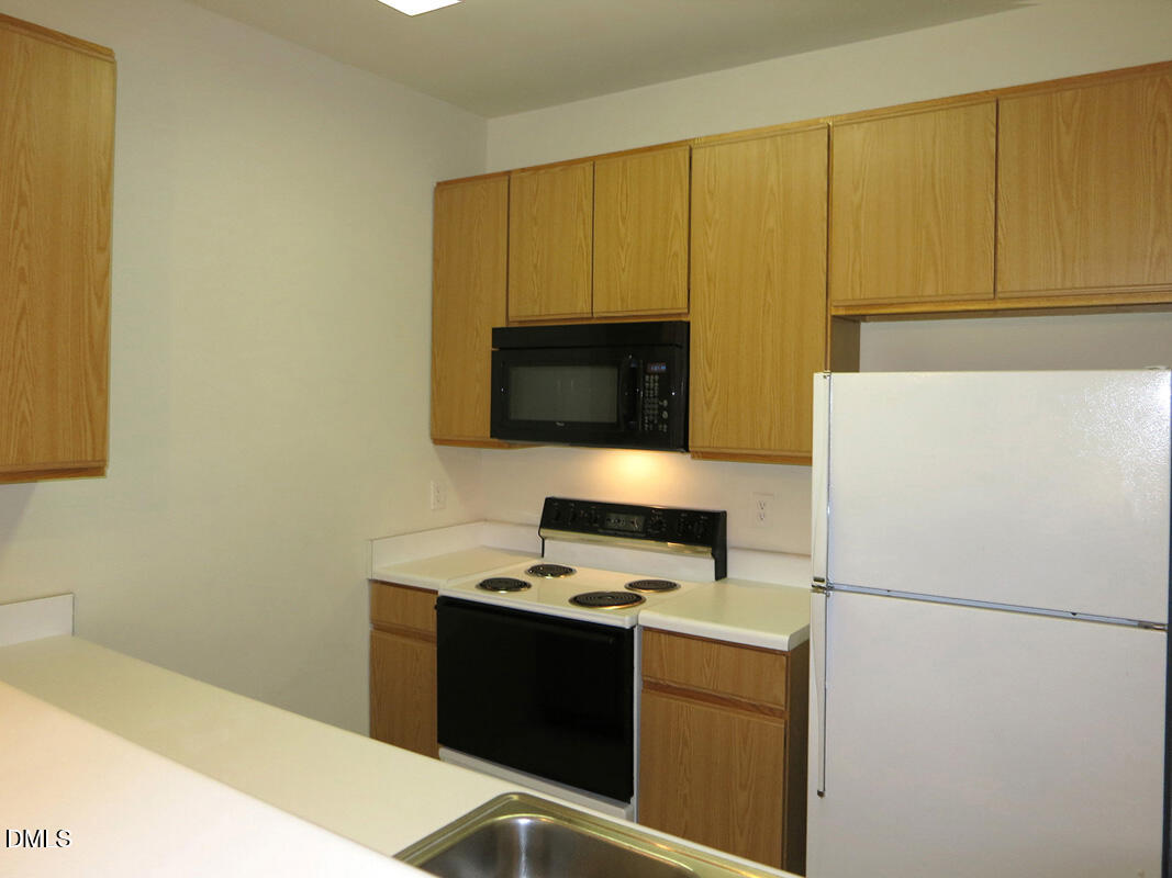 101 Rock Haven Road, Unit E502 Carrboro, NC 27510 - Photo 6 of 16 a kitchen with a refrigerator stove and microwave