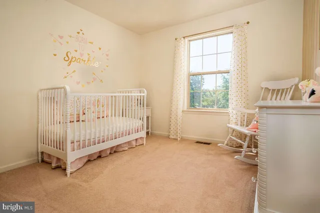 a view of a bedroom with furniture and windows