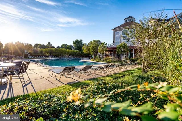 a view of a house with pool and sitting area