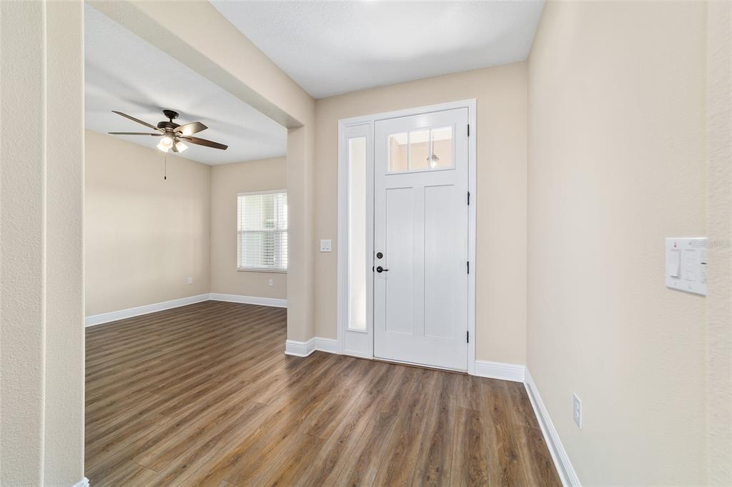 9778 Southwest 103rd Avenue Ocala, FL 34481 - Photo 11 of 57 wooden floor in an empty room with a window
