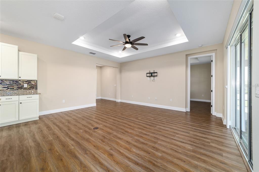 9778 Southwest 103rd Avenue Ocala, FL 34481 - Photo 16 of 57 wooden floor in an empty room with a window