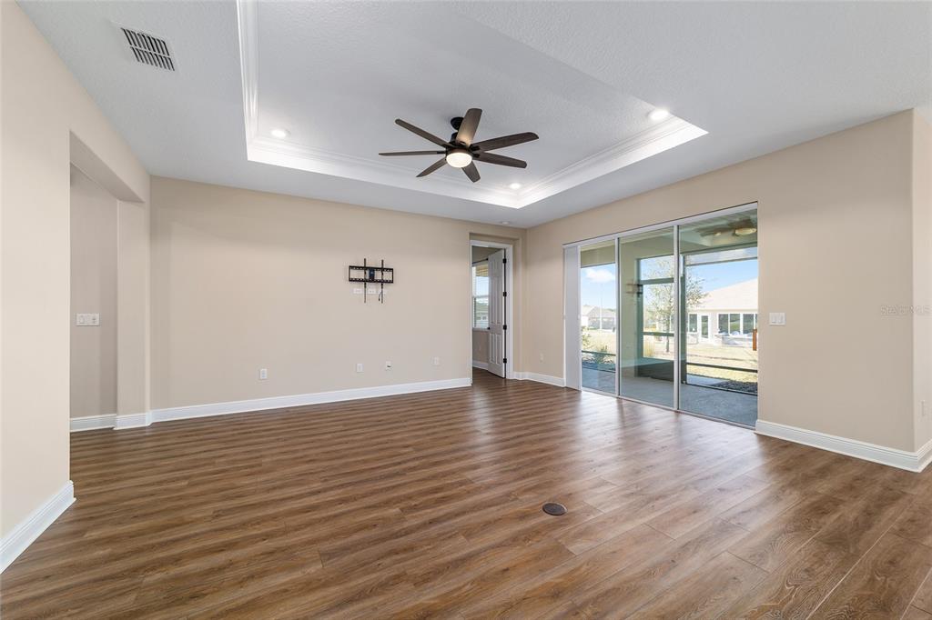 9778 Southwest 103rd Avenue Ocala, FL 34481 - Photo 18 of 57 a view of an empty room with a window and wooden floor