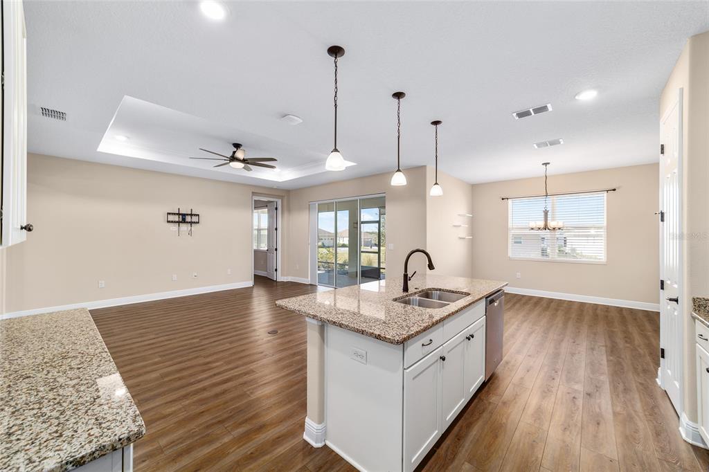 9778 Southwest 103rd Avenue Ocala, FL 34481 - Photo 28 of 57 a kitchen with a sink stove and wooden floor