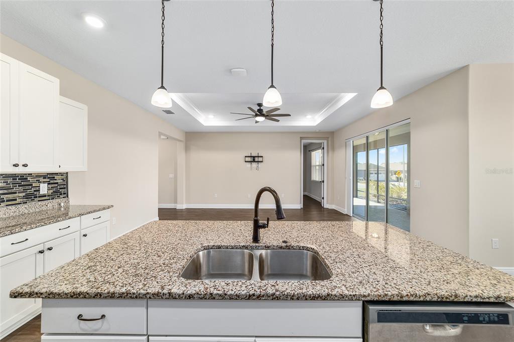 9778 Southwest 103rd Avenue Ocala, FL 34481 - Photo 29 of 57 a kitchen with sink granite counter top and living room view