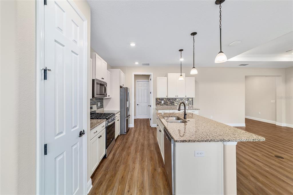 9778 Southwest 103rd Avenue Ocala, FL 34481 - Photo 30 of 57 a kitchen with stainless steel appliances granite countertop a sink stove and refrigerator