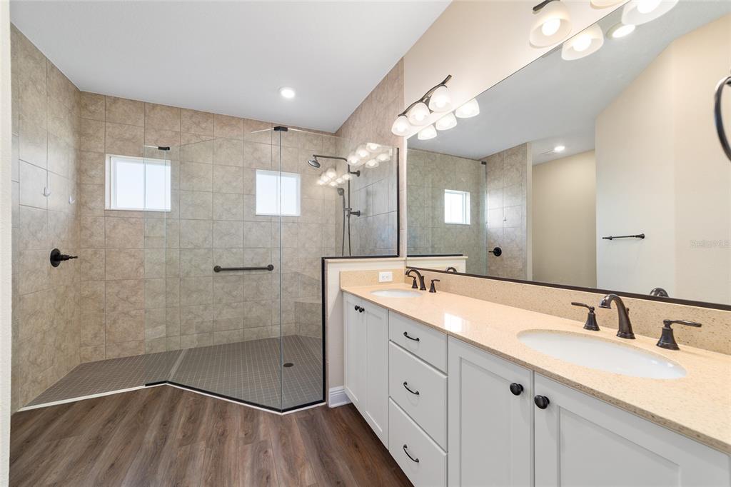 9778 Southwest 103rd Avenue Ocala, FL 34481 - Photo 35 of 57 a bathroom with a double vanity sink mirror and shower