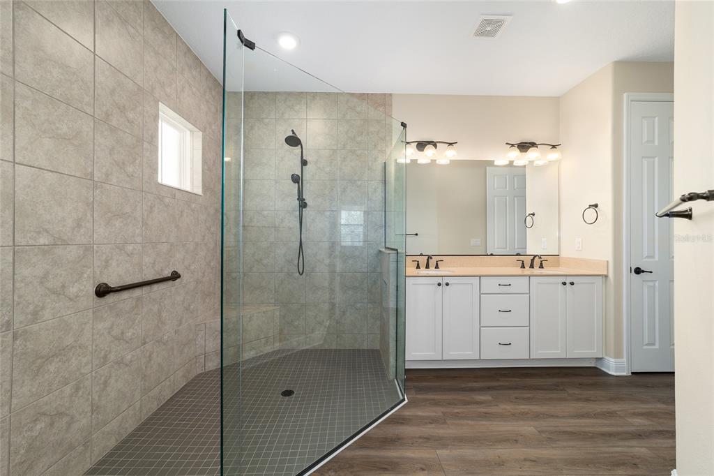 9778 Southwest 103rd Avenue Ocala, FL 34481 - Photo 36 of 57 a bathroom with a shower sink and mirror