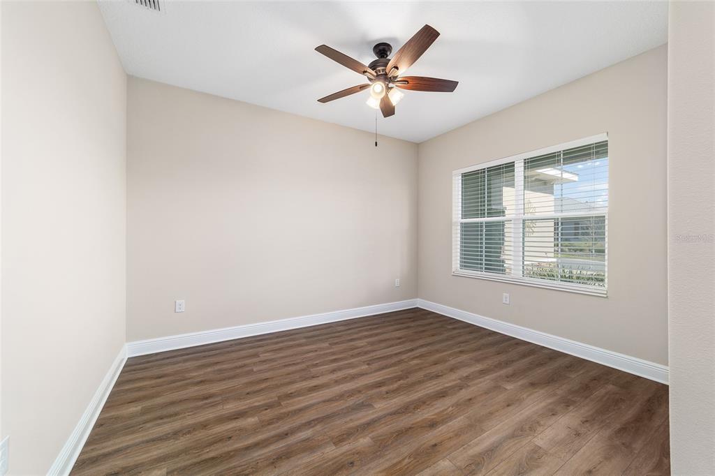 9778 Southwest 103rd Avenue Ocala, FL 34481 - Photo 39 of 57 an empty room with wooden floor and windows