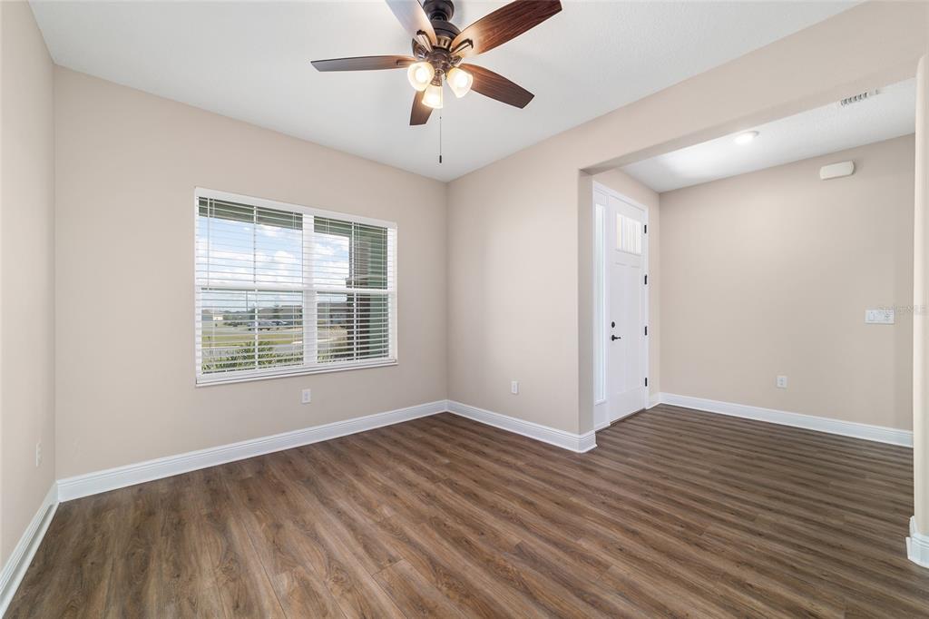 9778 Southwest 103rd Avenue Ocala, FL 34481 - Photo 40 of 57 a view of an empty room with wooden floor and a window