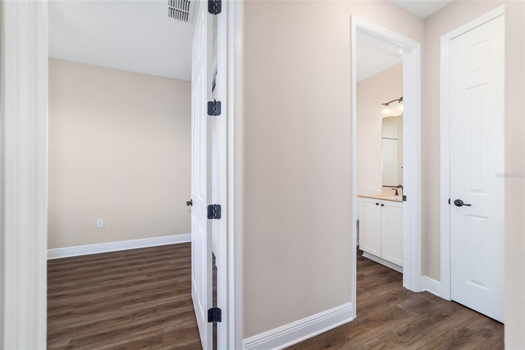 9778 Southwest 103rd Avenue Ocala, FL 34481 - Photo 41 of 57 a view of a hallway with wooden floor