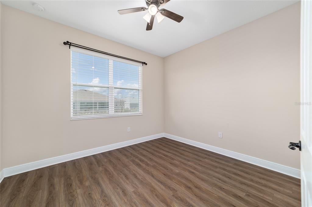 9778 Southwest 103rd Avenue Ocala, FL 34481 - Photo 42 of 57 wooden floor in an empty room with a window