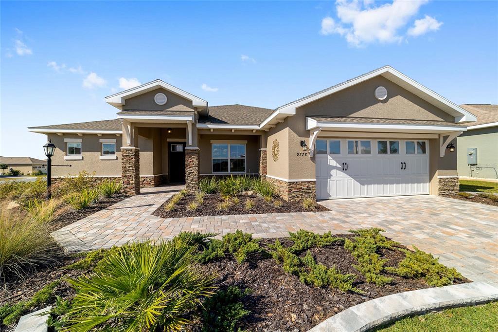 9778 Southwest 103rd Avenue Ocala, FL 34481 - Photo 5 of 57 a front view of a house with a yard and potted plants
