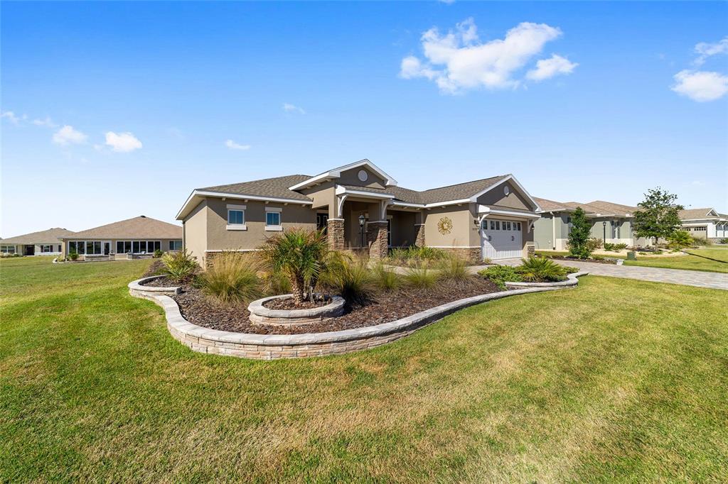 9778 Southwest 103rd Avenue Ocala, FL 34481 - Photo 7 of 57 a front view of a house with a yard