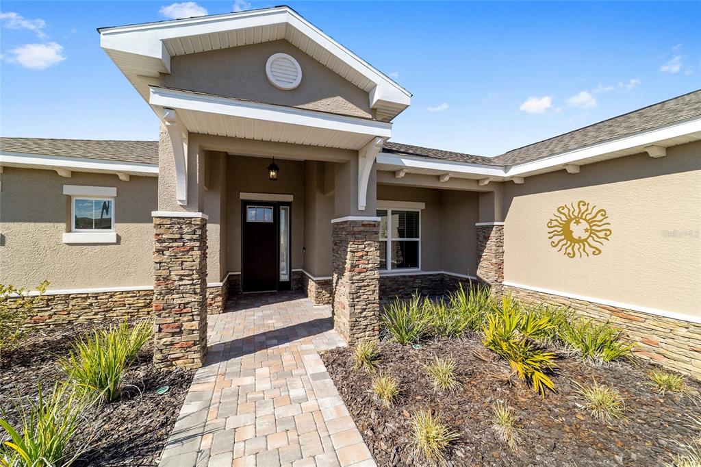 9778 Southwest 103rd Avenue Ocala, FL 34481 - Photo 8 of 57 a front view of a house with garden
